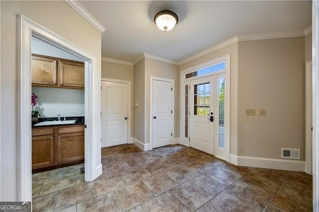 entrance foyer featuring ornamental molding and sink