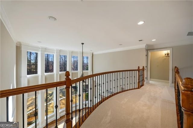 hall featuring light carpet and crown molding