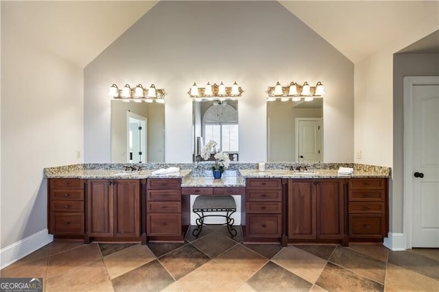 bathroom featuring vanity, tile patterned flooring, and high vaulted ceiling