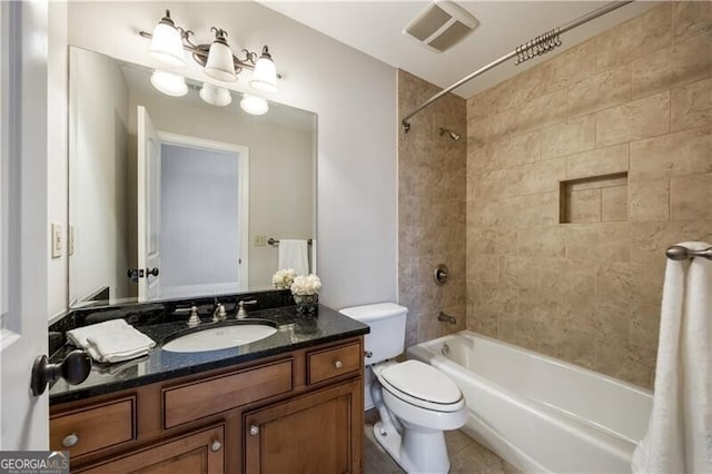 full bathroom with tiled shower / bath, vanity, toilet, and tile patterned flooring