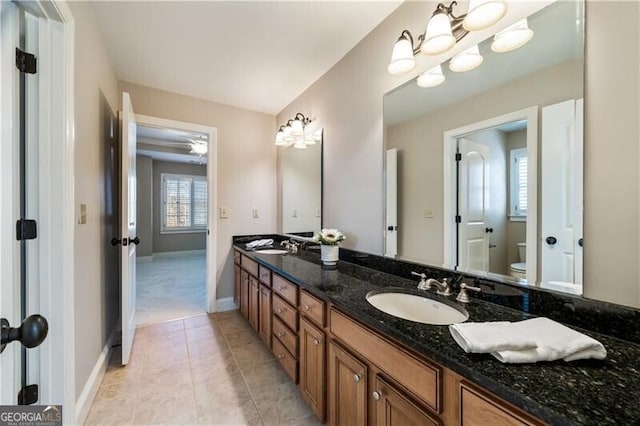 bathroom featuring vanity, tile patterned floors, and toilet