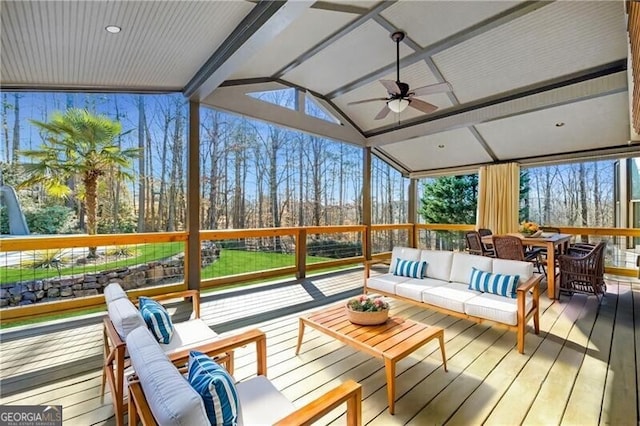 sunroom featuring ceiling fan and lofted ceiling