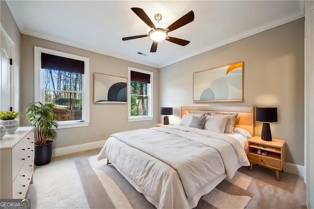 bedroom with ornamental molding, light colored carpet, and ceiling fan