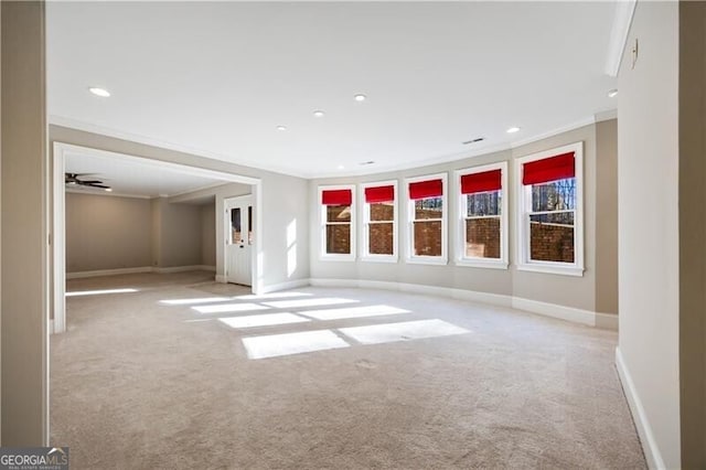 carpeted spare room with crown molding