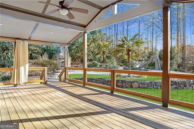 unfurnished sunroom featuring ceiling fan and vaulted ceiling