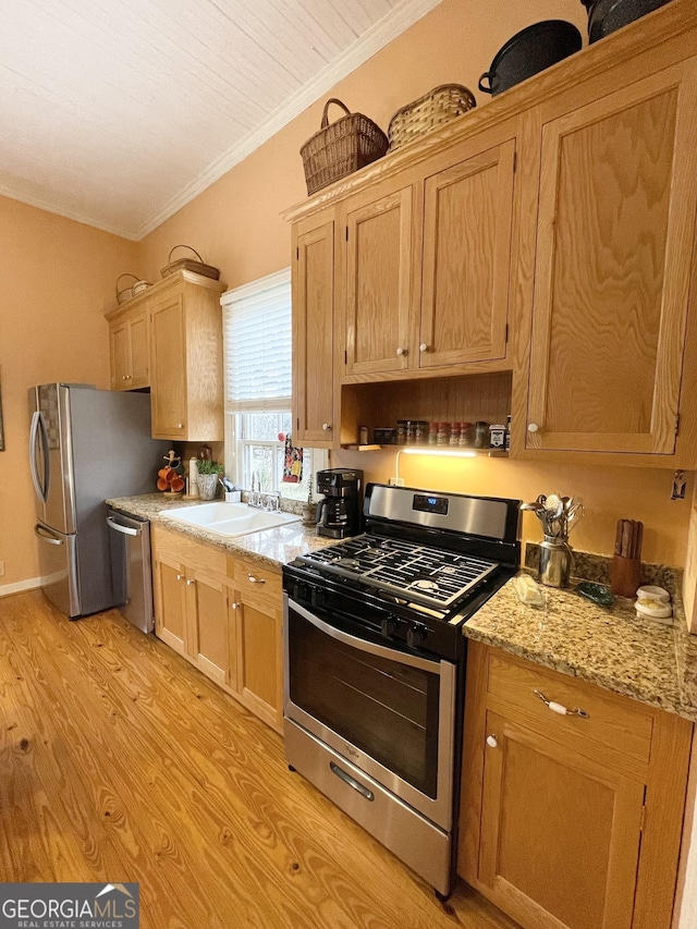 kitchen featuring light stone countertops, stainless steel appliances, light hardwood / wood-style floors, sink, and crown molding