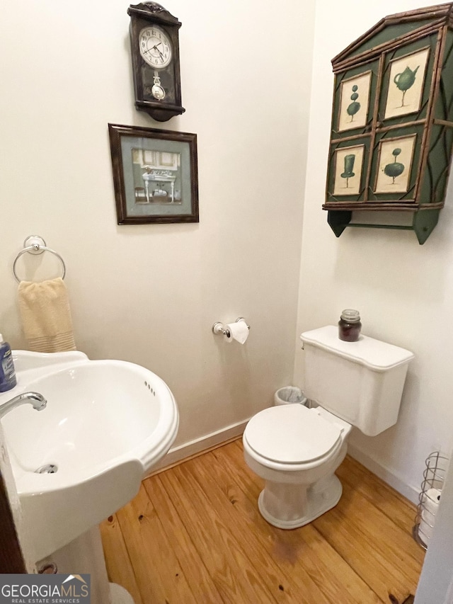 bathroom with wood-type flooring and toilet