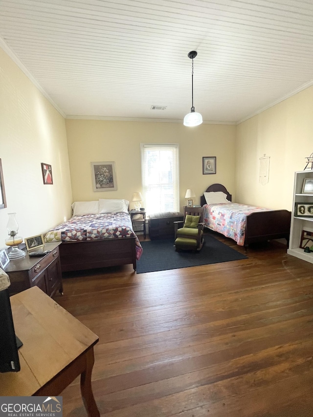 bedroom featuring dark hardwood / wood-style flooring and ornamental molding