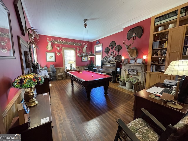 game room featuring ornamental molding, pool table, built in features, and dark hardwood / wood-style flooring