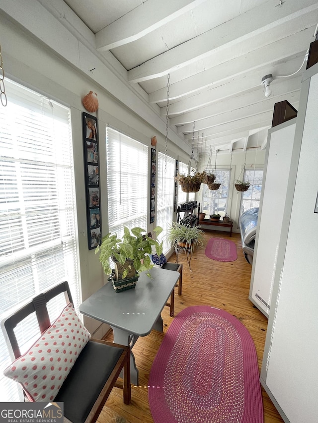 sunroom featuring beam ceiling