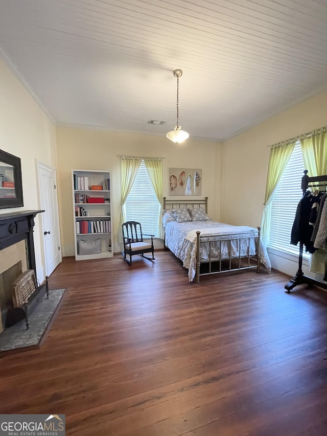 bedroom featuring dark wood-type flooring and multiple windows