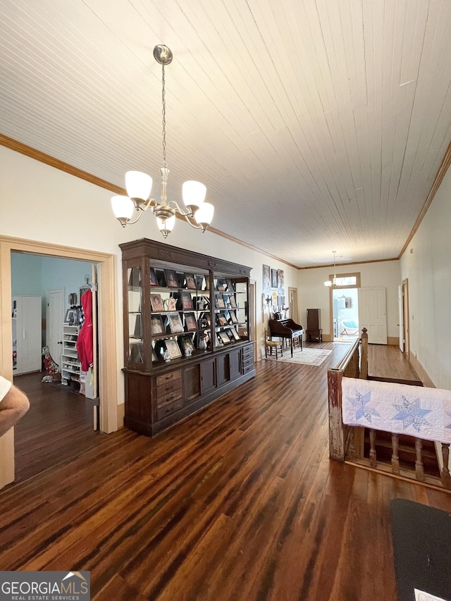 dining space featuring dark wood-type flooring, ornamental molding, wood ceiling, and an inviting chandelier