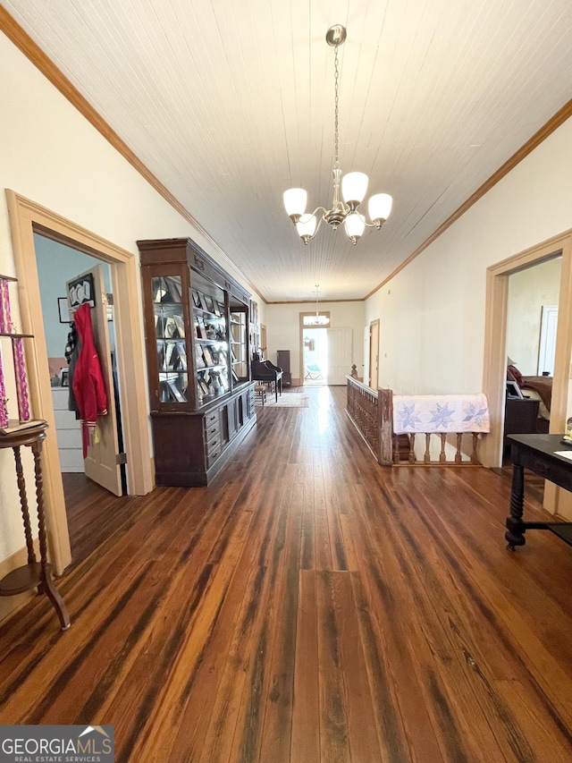 dining room with dark wood-type flooring, crown molding, and a chandelier