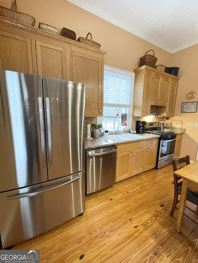 kitchen featuring light stone countertops, stainless steel appliances, sink, light hardwood / wood-style flooring, and crown molding