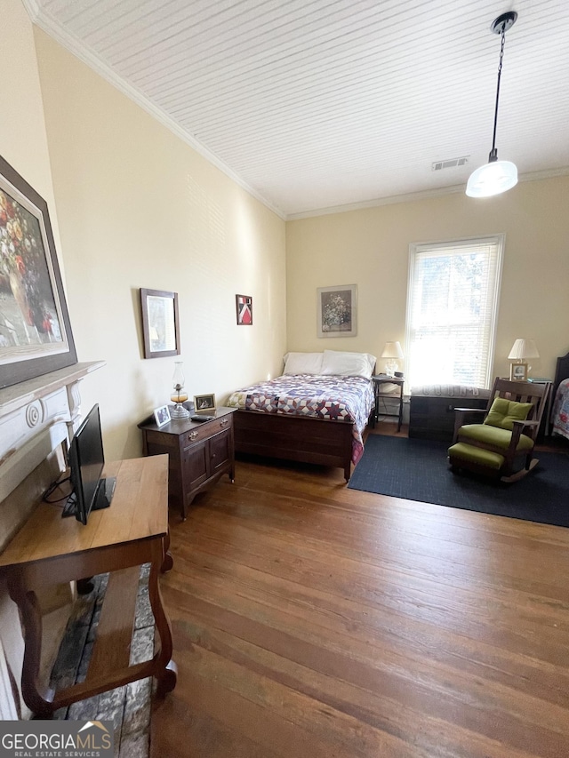 bedroom with crown molding and dark hardwood / wood-style floors