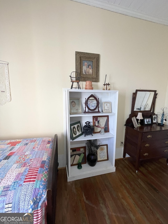 bedroom featuring dark hardwood / wood-style floors and crown molding