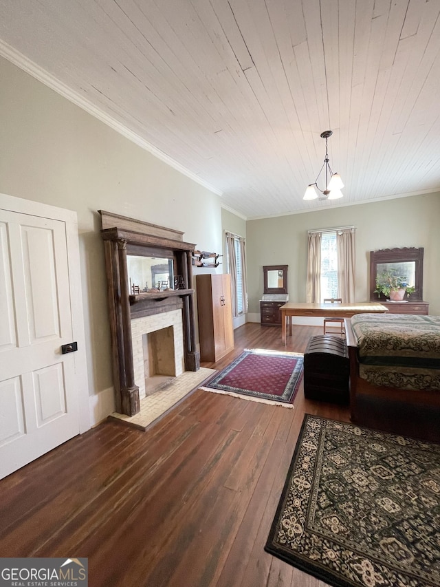 bedroom featuring a fireplace, hardwood / wood-style floors, crown molding, wood ceiling, and a chandelier