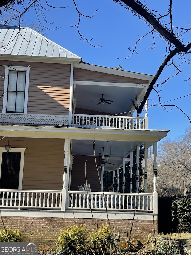 exterior space with ceiling fan, a balcony, and a porch