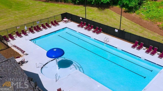 view of swimming pool with a yard and a patio