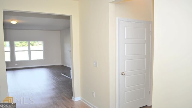 corridor featuring dark wood-type flooring