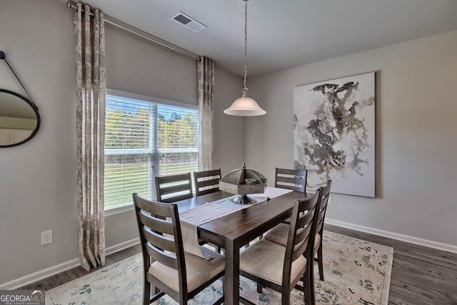 dining space featuring dark hardwood / wood-style floors