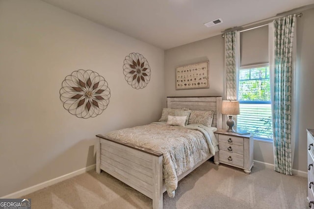 bedroom featuring light colored carpet