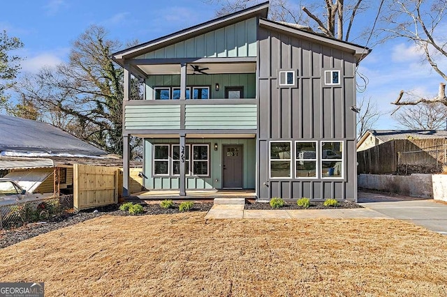 view of front of home with a balcony and ceiling fan