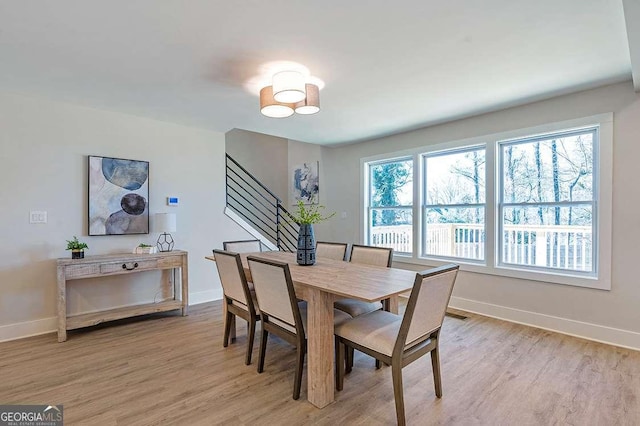 dining room with light wood-type flooring and a wealth of natural light