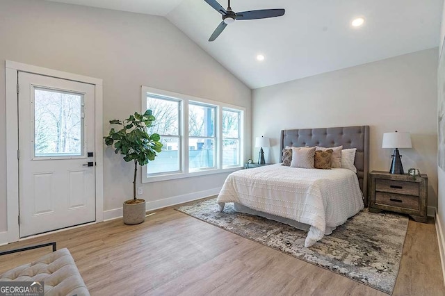 bedroom with ceiling fan, vaulted ceiling, and light hardwood / wood-style flooring