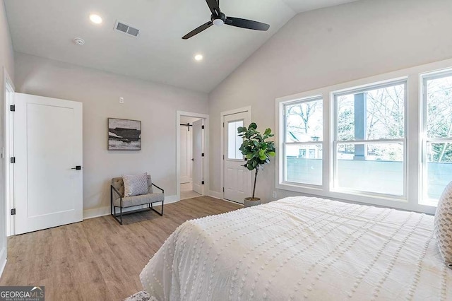 bedroom with ceiling fan, light hardwood / wood-style floors, and multiple windows