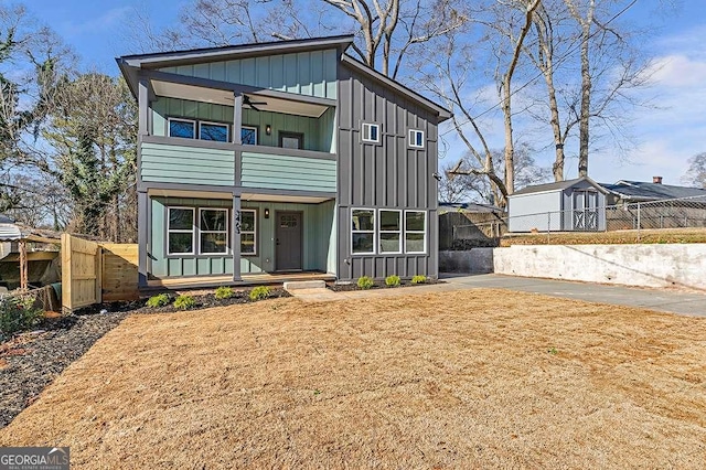 view of front of property featuring a balcony and ceiling fan