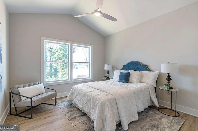 bedroom featuring ceiling fan, light hardwood / wood-style flooring, and vaulted ceiling