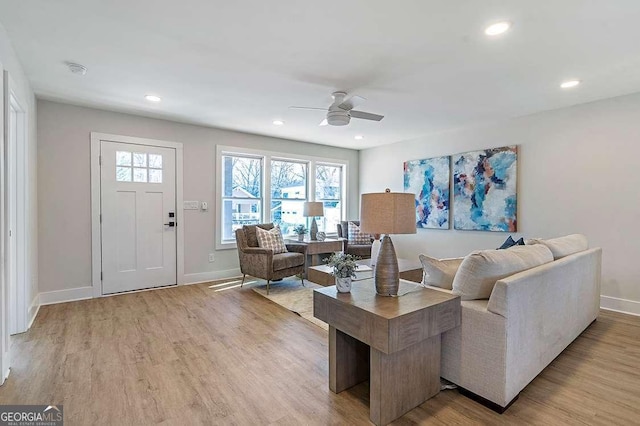 living room with ceiling fan and light hardwood / wood-style floors