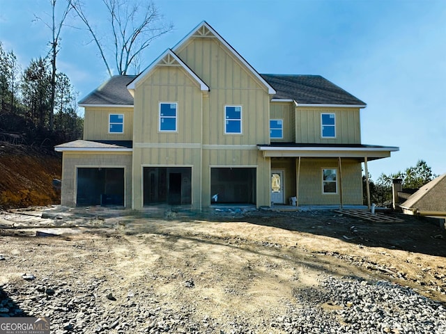 view of front of property featuring covered porch and a garage