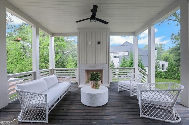 sunroom featuring ceiling fan and plenty of natural light