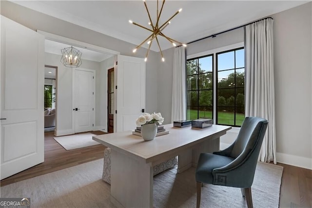 office with an inviting chandelier and light hardwood / wood-style flooring