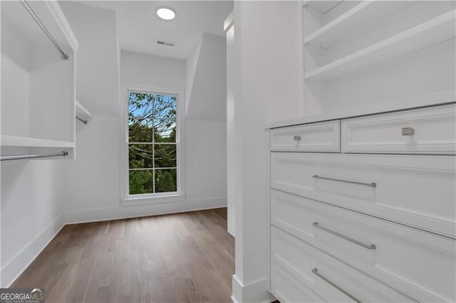 spacious closet with light hardwood / wood-style floors