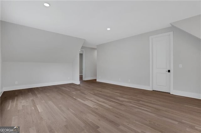 bonus room featuring vaulted ceiling and hardwood / wood-style floors