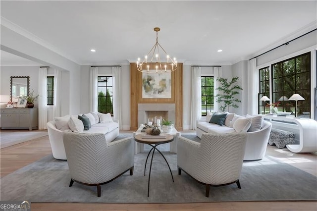 living room with an inviting chandelier and ornamental molding