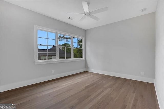 empty room featuring ceiling fan and hardwood / wood-style floors