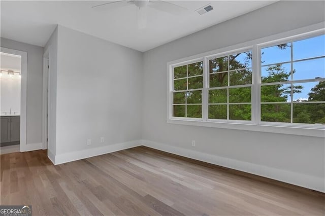 spare room featuring ceiling fan and light hardwood / wood-style flooring