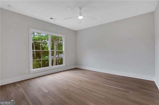 unfurnished room with ceiling fan and hardwood / wood-style flooring