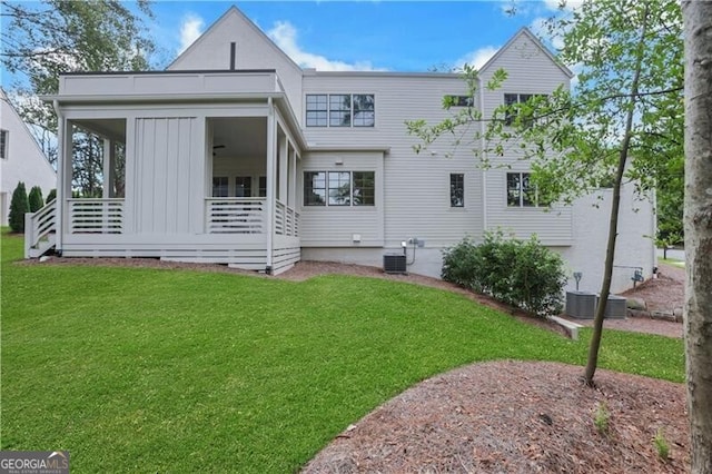 rear view of property with a yard and central air condition unit