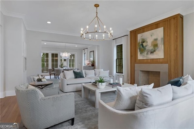 living room featuring crown molding, a chandelier, and hardwood / wood-style floors