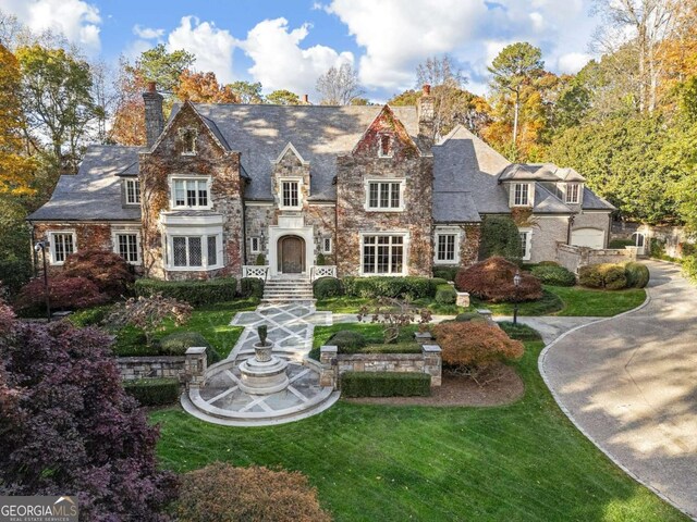 english style home with a front yard