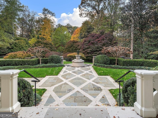 view of community featuring a yard and a patio