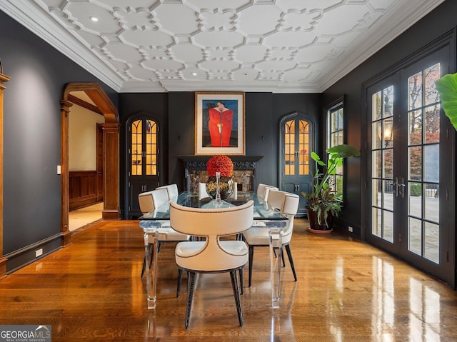 dining room with ornamental molding and french doors