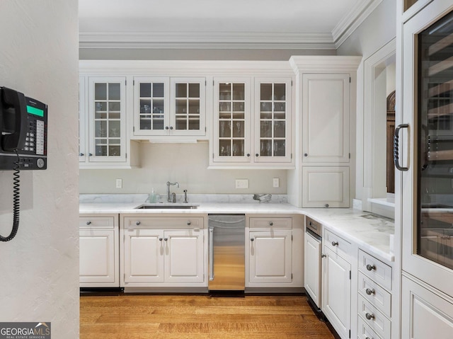 bar featuring sink, white cabinets, and light hardwood / wood-style flooring