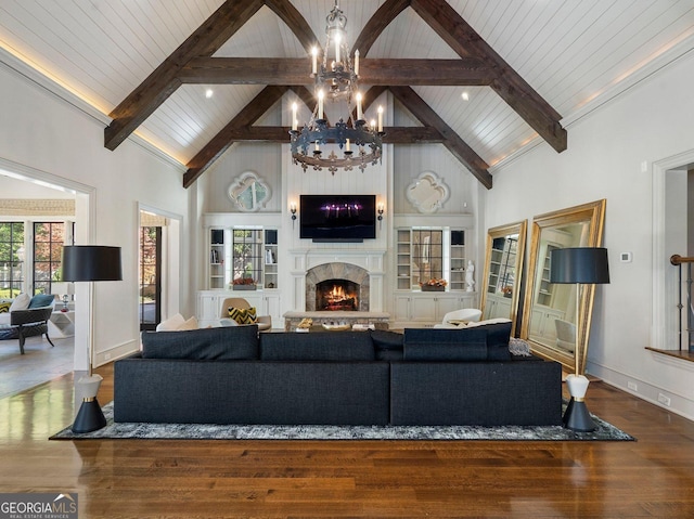 living room featuring high vaulted ceiling, hardwood / wood-style floors, beam ceiling, and an inviting chandelier