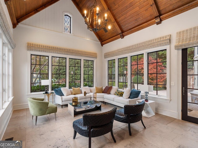 sunroom / solarium featuring wooden ceiling, a healthy amount of sunlight, vaulted ceiling with beams, and a notable chandelier